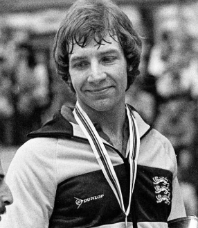 UTT ambassador John Hilton holding his European table tennis gold medal, representing Greater Manchester TT Academy.