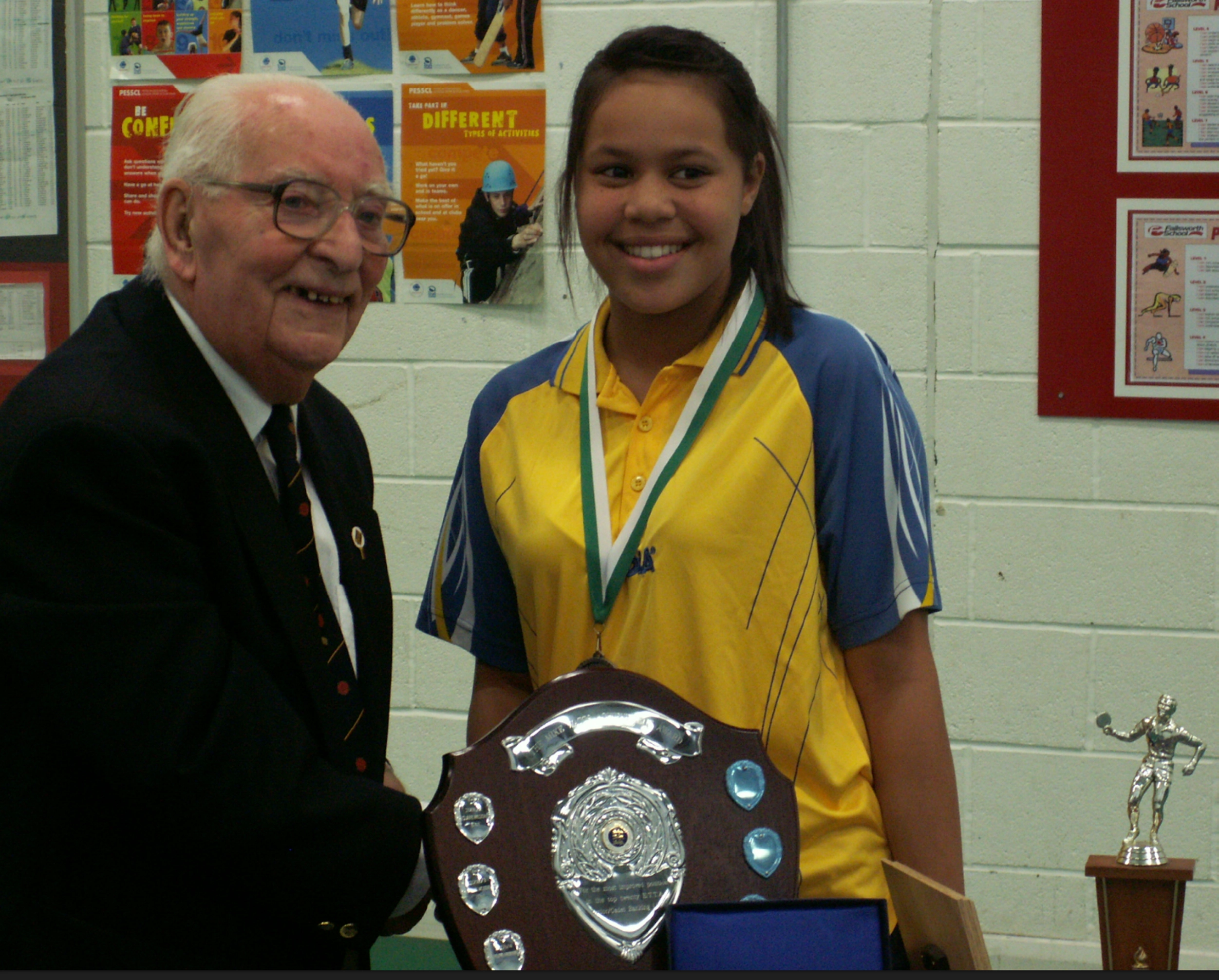 Rebekah Higgs -Rebekah Griffith- shaking hands with referee Ken Armson MBE, receiving her national table tennis awards.